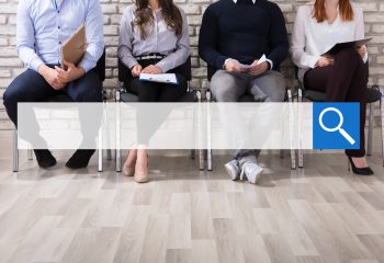 Close-up Of Business People Sitting On Chair Waiting For Job Interview In Office