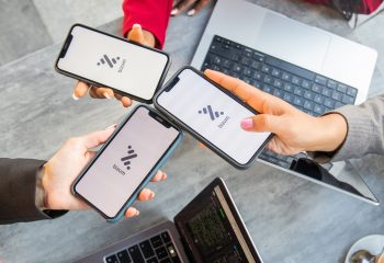 Tenerife, Spain, 13 January 2023: Three businesswomen during a meeting pay the bill with Bizum, a fast money exchange system