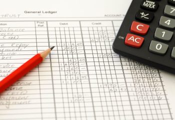 Handwritten,Accounting,Ledger,Showing,Bookkeeping,Using,Pencil,And,Calculator.
