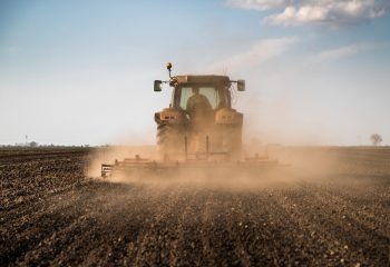Tractor,Cultivating,Field,At,Spring