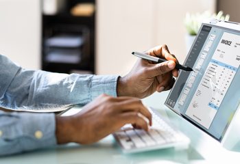 Business Accountant Using Electronic Bill On Laptop Computer