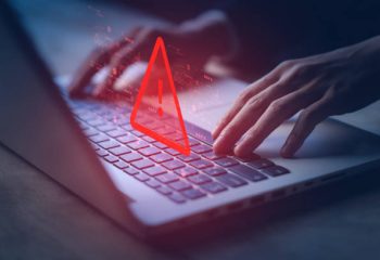 System hacked warning alert on notebook (Laptop). Cyber attack on computer network, Virus, Spyware, Malware or Malicious software. Cyber security and cybercrime. Compromised information internet.