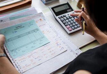 Asian woman working through paperwork