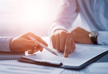 Business,People,Negotiating,A,Contract.,Human,Hands,Working,With,Documents