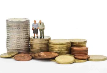 Seniors figurines with euro coins isolated on white background