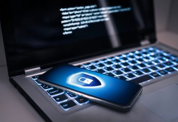 Phone lock to protect from cyber scam, online data fraud or identity theft. Laptop with hacker virus code in screen. Phishing, cybersecurity danger or ransomware attack. Encrypted privacy in email.