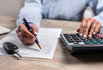 Concept of buying or renting new car at dealership.  Successful completion deal. Filling document