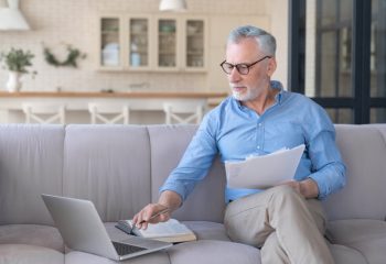 Working,Serious,Old,Senior,Elderly,Businessman,Paying,Domestic,Bills,Online