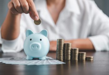 Saving investment banking finance concept. Stack of coins with piggy bank on the table. Growth of loan and investment business idea. Asset Management, Funds, Liabilities, Deposits, Income, Successful.