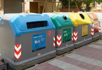Viladecasn, SPAIN - JULY 22, 2024: A row of colorful recycling bins in an urban setting, each designated for different types of waste.