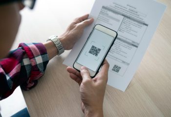 A,Man,Uses,A,Smartphone,To,Scan,The,Qr,Code