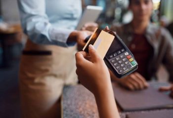 Close,Up,Of,Woman,Paying,Contactless,With,Credit,Card,In